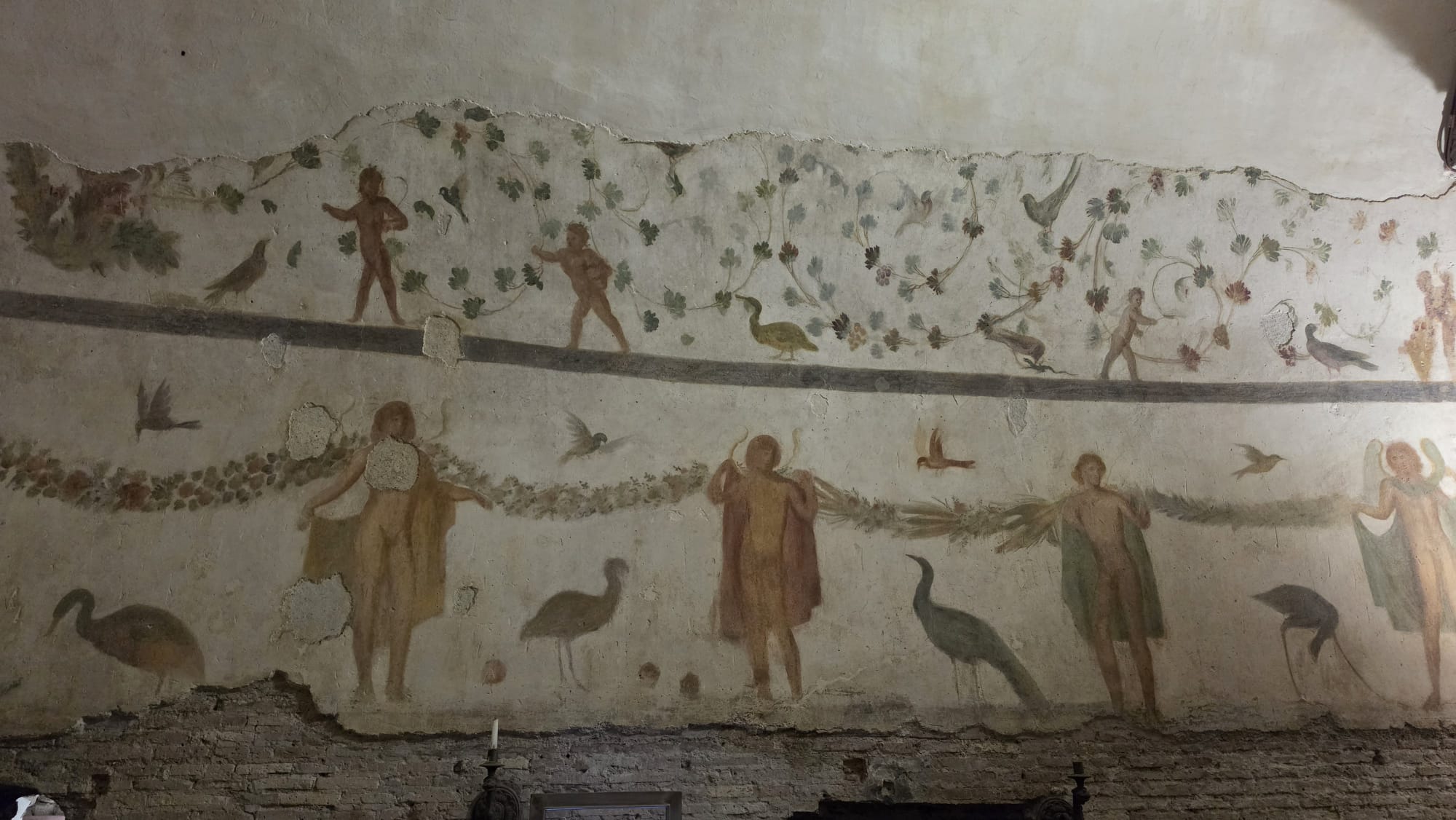 Roman wall paintings with figures, birds and vegetation at the Case Romane del Celio